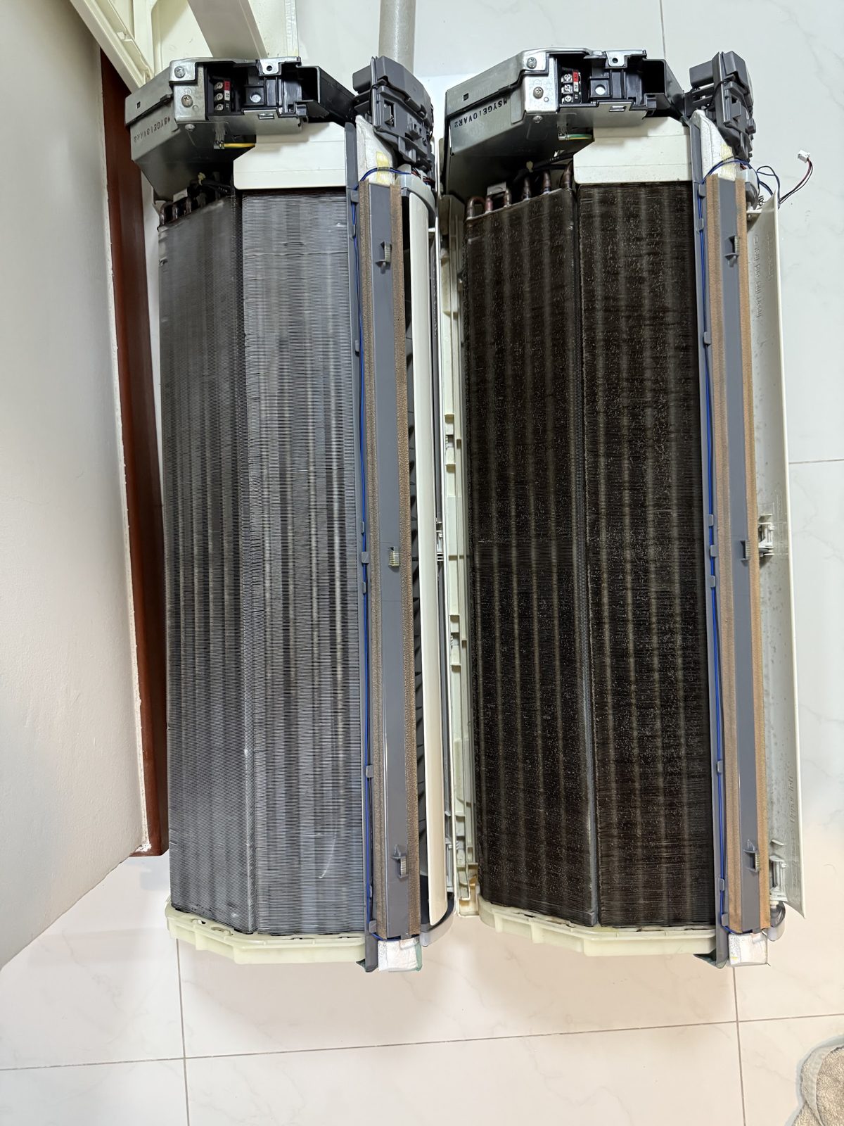 Two aircon evaporator coils side by side, one cleaned and one still black with dirt
