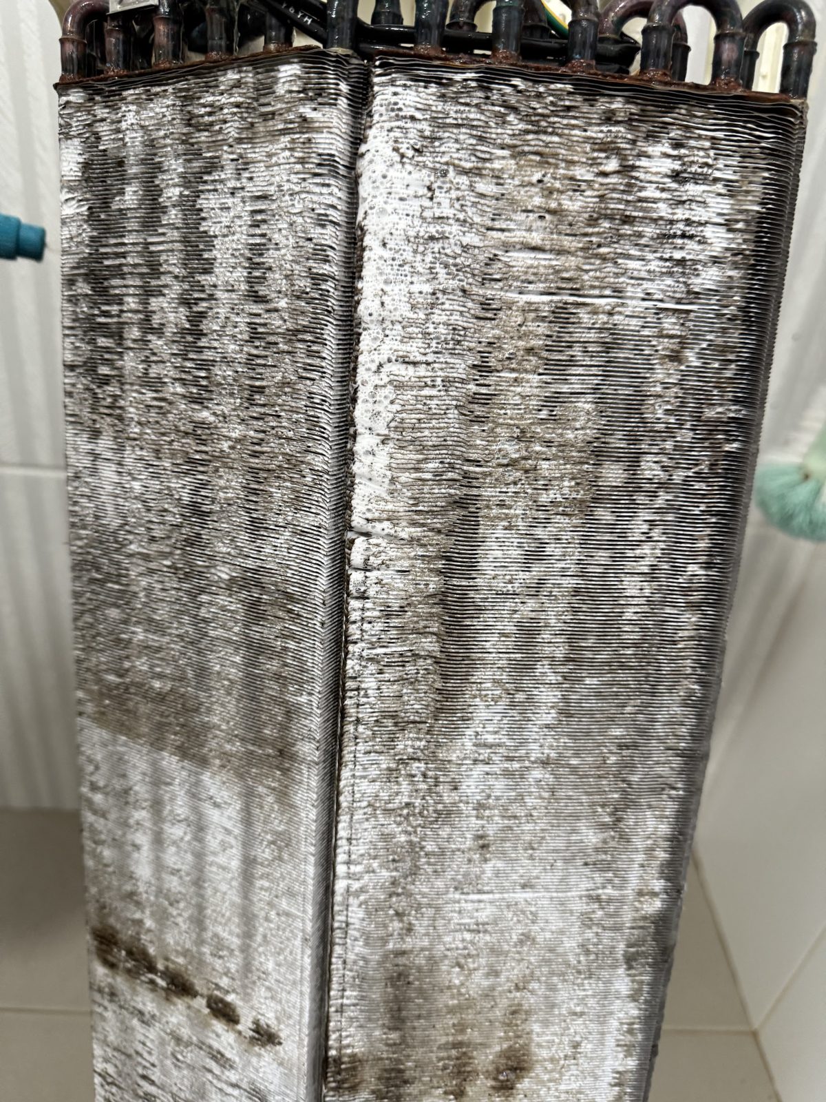 A fan barrel and coil during a chemical wash